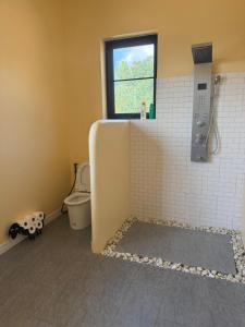 a bathroom with a shower and a toilet and a window at Phangan Sky Villa in Ban Madua Wan +14 photos