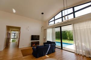 a living room with two blue chairs and a tv at Phangan Sky Villa in Ban Madua Wan