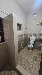 a bathroom with a toilet and a shower at Yara Homes in Cochin