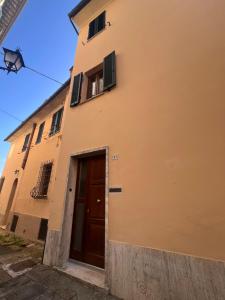 a yellow building with a door and a window at Prugnolo Grand View in Montepulciano