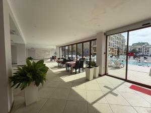 a room with tables and chairs in a building at Motel Hanat in Saints Constantine and Helena