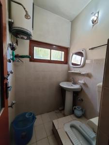 a small bathroom with a sink and a toilet at Indus Motel in Skardu