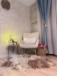 a chair sitting in a room with a furry rug at Boutique apartment Bansko Bell Tower in Bansko