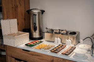 a counter with several different types of food on it at Hotel Urban Bliss in Tbilisi City