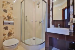 a bathroom with a shower and a toilet and a sink at Eden in Rydzyna +26 photos