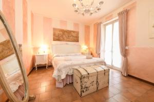 a bedroom with a bed and a chandelier at Relais De La Place - Downtown in Desenzano del Garda