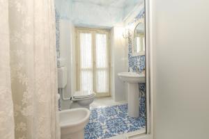 a bathroom with a toilet and a sink at Relais De La Place - Downtown in Desenzano del Garda +74 photos