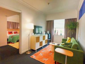a hotel room with a bed and a living room at Macau Hotel S in Macau +67 photos