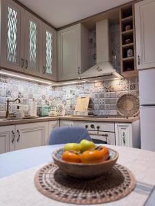 a bowl of fruit on a table in a kitchen at Boutique apartment Bansko Bell Tower in Bansko