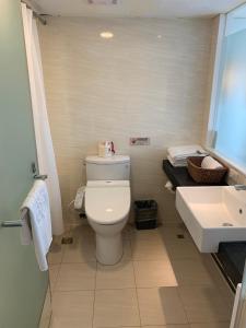 a bathroom with a white toilet and a sink at Eastin Taipei Hotel in Taipei