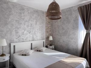 a bedroom with a white bed and a window at Boutique apartment Bansko Bell Tower in Bansko