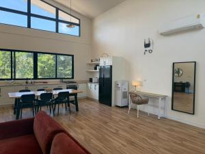 a kitchen and living room with a couch and a table at Phangan Sky Villa in Ban Madua Wan