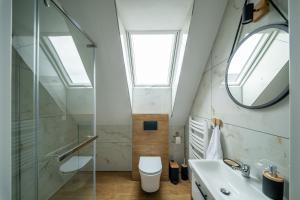 a bathroom with a sink and a toilet and a skylight at Szczyt i Sosna in Krauszów +51 photos