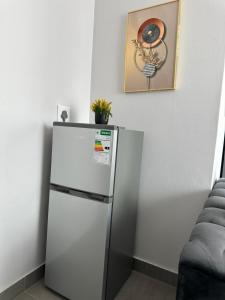 a refrigerator in a room with a picture on the wall at Apartment in joburg in Johannesburg