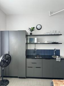 a kitchen with a sink and a clock on the wall at Apartment in joburg in Johannesburg