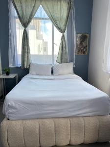 a large bed in a bedroom with a window at Apartment in joburg in Johannesburg