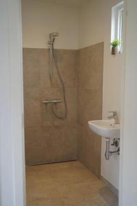 a bathroom with a shower and a sink at Feriehusene Hedensted Centret - Sport, natur og velvære in Hedensted - Midtjylland +10 photos