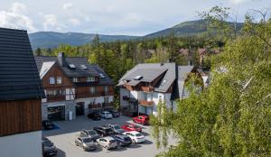 an aerial view of a town with cars parked in a parking lot at Hotel Bergo Resort & SPA in Szklarska Poręba