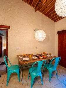 a dining room with a table and four chairs at Bird Songs in Rāmgarh