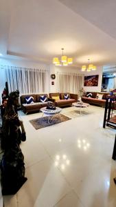 a large living room with couches and tables at Bohol Ramyer Villa in Totolan