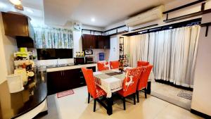 a kitchen with a table and chairs in a kitchen at Bohol Ramyer Villa in Totolan