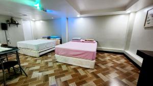 a room with two beds and a table at Bohol Ramyer Villa in Totolan +52 photos