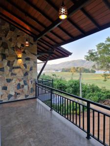 a balcony with a view of the mountains at OASIS Victoria Lounge! in Kandy