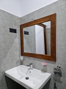 a bathroom with a white sink and a mirror at OASIS Victoria Lounge! in Kandy +52 photos