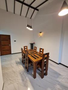 a dining room with a wooden table and chairs at OASIS Victoria Lounge! in Kandy