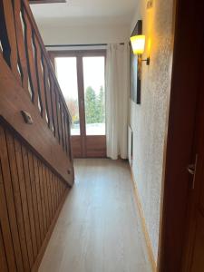 a hallway with a staircase and a large window at Le Refuge in Vérossaz +15 photos