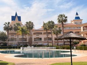 a resort with a swimming pool in front of a building at Life Apartments Costa Ballena in Costa Ballena