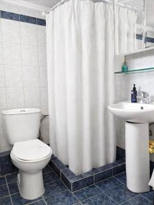 a bathroom with a toilet and a sink at E&M Villa Sea View in Polychrono +18 photos