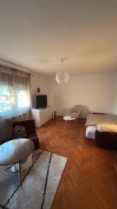a living room with a bed and a table at Magnolia guest house in Karlovac +28 photos