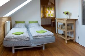 a bedroom with a bed with green pillows on it at Fair Haven - Dobrej přístav in Lomnice nad Popelkou
