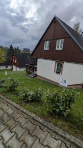 a house with a sign in front of it at Chata Větrník u Černého dolu v Krkonoších in Lauterwasser
