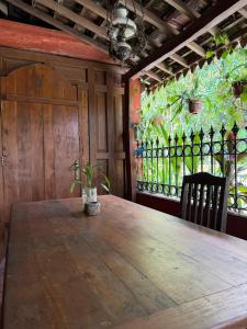 a wooden table with a potted plant on top of it at Rumah Ukhi Guest House in Yogyakarta
