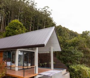 a house with a metal roof on a wooden deck at Andriyala in Haputale