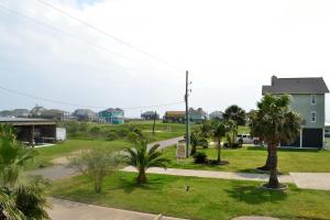 a view of a park with palm trees and buildings at Casa Carmen home in Crystal Beach