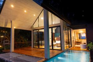 a house with a swimming pool in front of it at Andriyala in Haputale