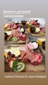 a table topped with different types of meats and cheese at Zeitlos Boutiquehotel in Limburg an der Lahn
