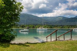 two boats are docked at a dock on a lake at Hotel Försterhof lebe pur, genieße den Tag in St. Wolfgang