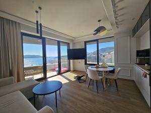 a living room with a couch and a table at Green Stone lamela B in Rafailovici