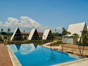 a view of a resort with a swimming pool at Grand Luxcamp Pangandaran by Horison in Pangandaran