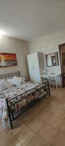 a bedroom with a bed and a table and a mirror at Sleep and Travel in Focene