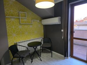 a room with a table and two chairs and a window at Boutique Apartment with Jacuzzi Pleven in Pleven