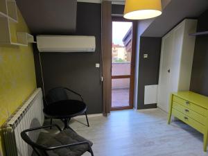 a room with a table and a chair and a desk at Boutique Apartment with Jacuzzi Pleven in Pleven