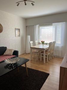 ein Wohnzimmer mit einem Tisch und ein Esszimmer in der Unterkunft Linjuri in Varkaus