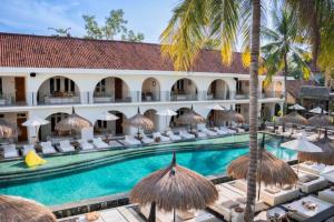 an image of a resort with a swimming pool at Dwayne 1 BR Standard Room in Kuta Lombok