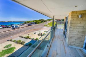 an apartment balcony with a view of a street at West Beach House in Esperance