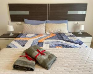 a bedroom with a bed with towels on it at KAIROS HOME y Garaje , Algemesí Home in Algemesí